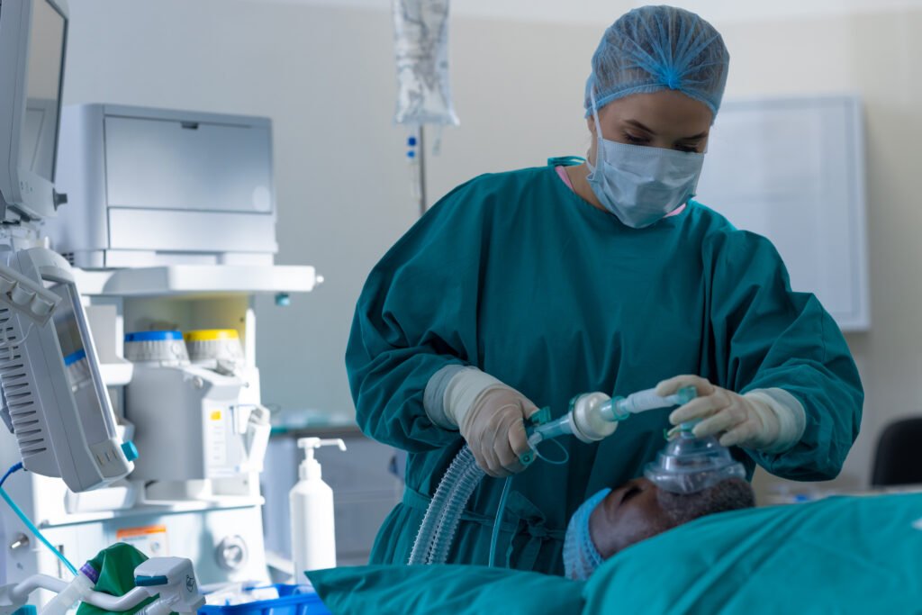 caucasian female surgeon placing anaesthetic face mask on patient in operating theatre at hospital. hospital, surgery, hygiene, medicine, healthcare and work, unaltered.